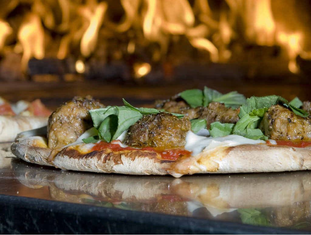 Homemade pizzas make a versatile and delicious option for entertaining friends and family. Homemade pizzas make a versatile and delicious option for entertaining friends and family.